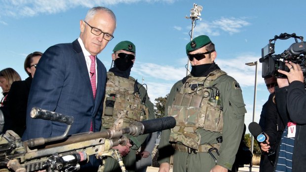 Prime Minister Malcolm Turnbull examines some military hardware during a media conference at Holsworthy Barracks.