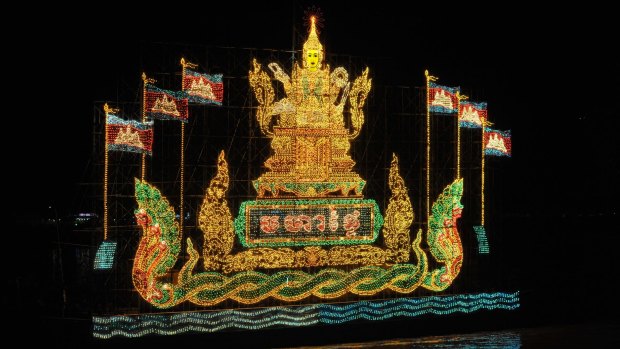 An illuminated float with Cambodian flags during the water festival.
