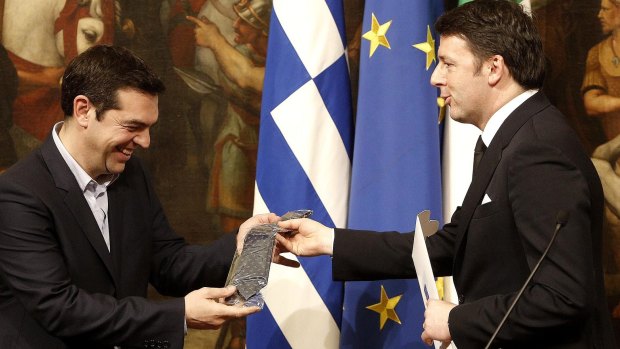 A lesson in Italian style: Greek Prime Minister Alexis Tsipras is presented with a tie by Italian Premier Matteo Renzi at the end of a joint press conference at Rome's Palazzo Chigi government office. 