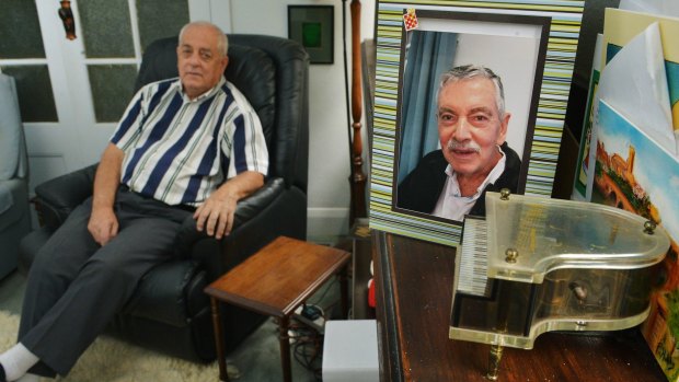 Tony Walsh (left) with a picture of his partner Paul Wenn, who died last year.