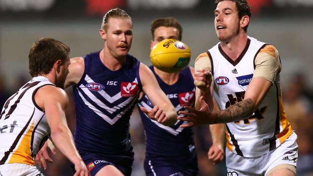 Kaiden Brand of the Hawks hand balls during the round 18 AFL match between the Fremantle Dockers and the Hawthorn Hawks.