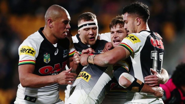 Packing Panthers: Nathan Cleary of the Panthers is mobbed by teammates after scoring a try.