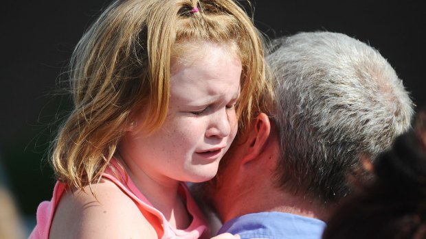 Lilly Chapman, 8, cries after being reunited with her father, John Chapman at Oakdale Baptist Church on in Townville, South Carolina after the shooting. 