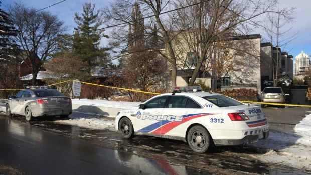 Police cars parked outside the home of billionaire Barry Sherman.