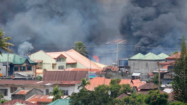 Smoke rises following airstrikes by Philippine Air Force to retake control of Marawi city, southern Philippines.