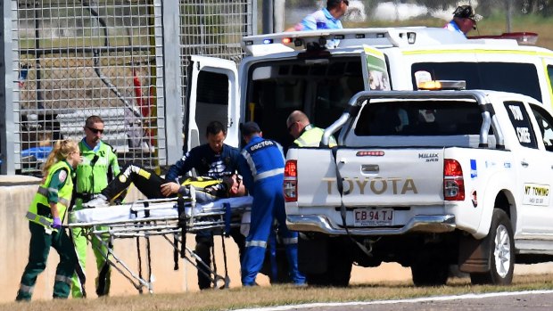 Lee Holdsworth is stretchered into an ambulance after crashing in Darwin.