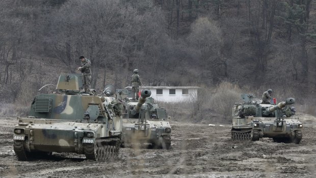South Korean army soldiers stand on their K-55 self-propelled howitzers during exercises near the North Korean border.