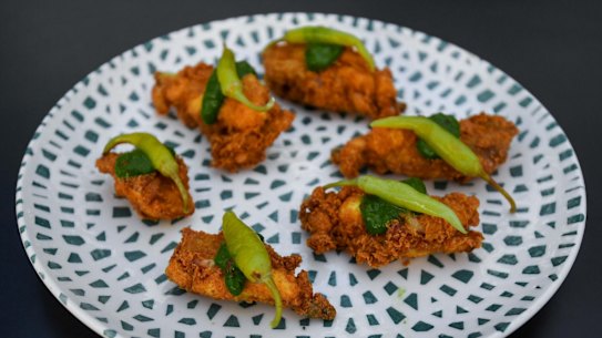 Deep-fried chicken ribs with chimichurri and guindilla peppers.