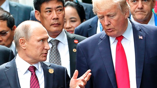 US President Donald Trump and Russia's President Vladimir Putin talk during a photo session at the APEC Summit in Danang, Vietnam.