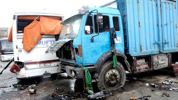 A released by the official Syrian news agency SANA shows damaged buses and trucks after Saturday's twin explosions in Damascus.