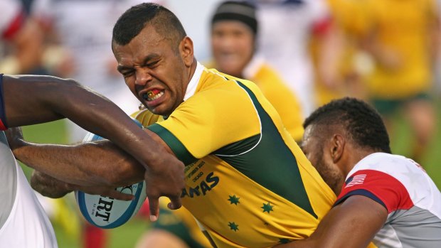 Tough going: Kurtley Beale is tackled by the USA defence.