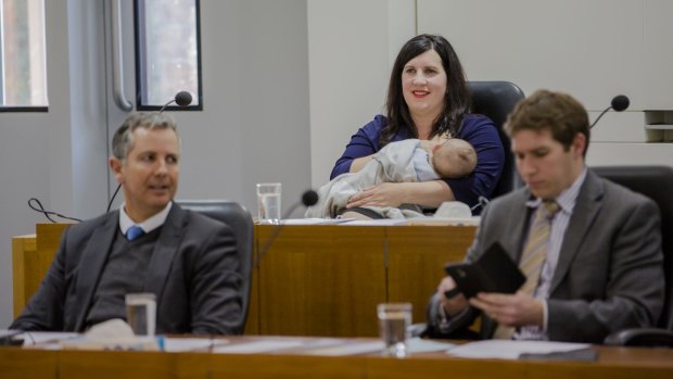 Giulia Jones, with Liberal colleagues Jeremy Hanson and Alistair Coe, makes history breastfeeding son Maximus in the ACT Chamber in August.