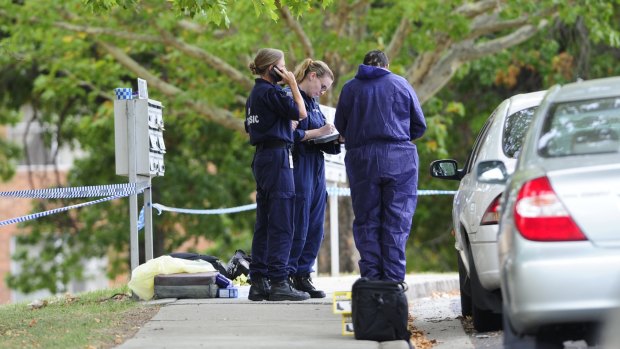 Police investigating the suspicious death at the Stuart Flats in Griffith on Monday.