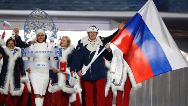 Alexander Zubkov of Russia carries the national flag as he leads the team during the opening ceremony of the 2014 Winter Olympics in Sochi, Russia. 