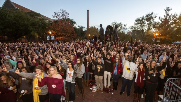 University students hold a vigil on campus after the shooting of three students. 