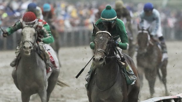 Mud in their eye: Kent Desormeaux rides Exaggerator to win the Preakness Stakes at Pimlico Race Course on Saturday.