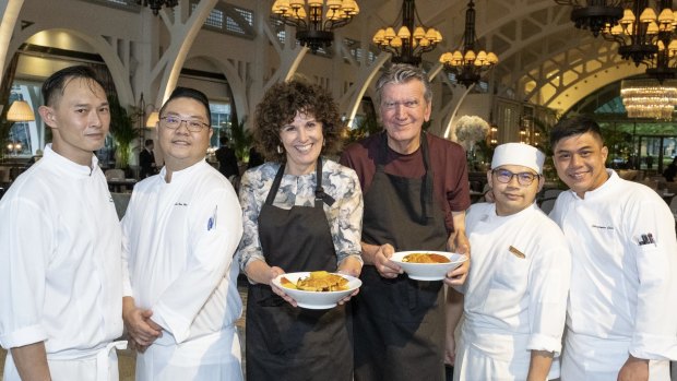 Job done: Jill Dupleix and Terry Durack with some of the kitchen team at The Fullerton, Singapore.