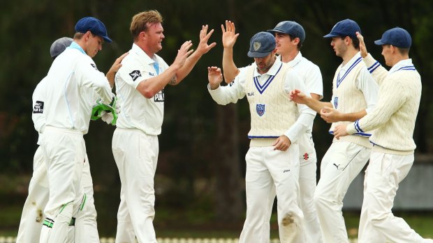 Breakthrough: Doug Bollinger and his NSW teammates celebrate the wicket of Beau Webster.