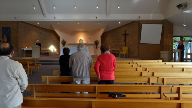 Parishioners attend morning mass at St Mary Magdalen in 2012, after Father Grasby was placed on leave.