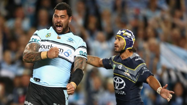 Contrasting fortunes: Johnathan Thurston and Andrew Fifita react to an apparent try that was later disallowed.