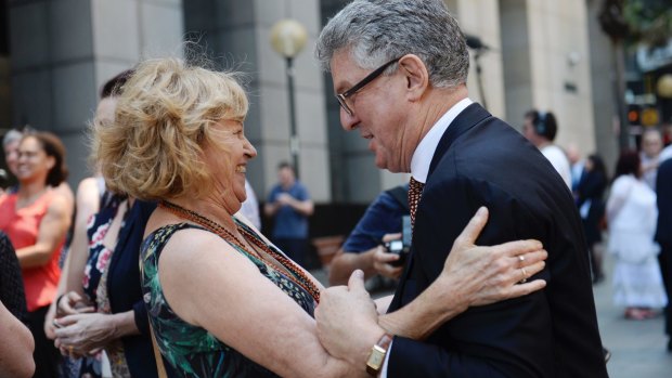 Joan Isaacs, one of the first to give evidence against the Catholic Church, hugs David Marr outside the Royal Commission. 