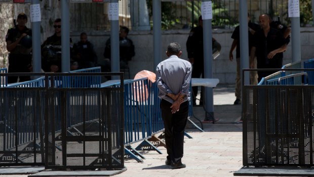 A Palestinian man walks towards a metal detector at the Al-Aqsa Mosque compound in Jerusalem's Old City.