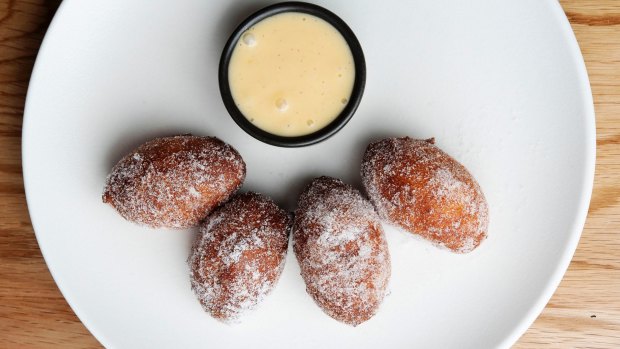 Yeasty, sugar-coated zeppole doughnut balls with vanilla custard.