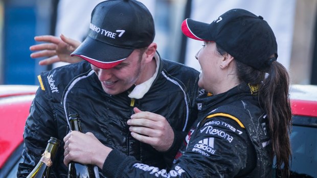 Champagne rivalry: Harry Bates and Molly Taylor celebrate their achievements on the podium at the National Capital Rally.