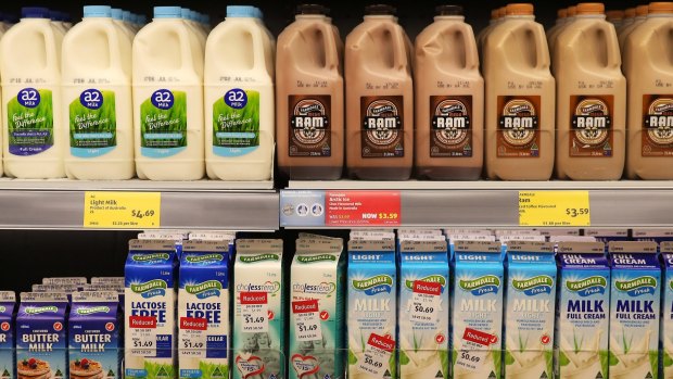Cartons and bottles of milk products sit on display for sale