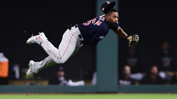 Big heave: Boston's Jackie Bradley Jr. puts all his strength behind a throw to home plate.