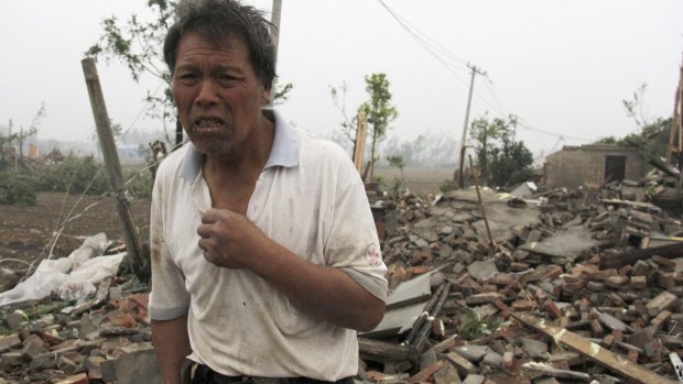 A villager stands near houses destroyed by a tornado that hit the Chinese province of Jiangsu on Thursday.