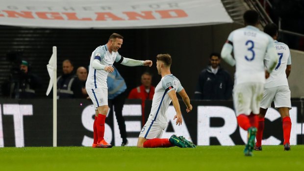 Rare goal: England's Gary Cahill is congratulated by Wayne Rooney, after his goal.