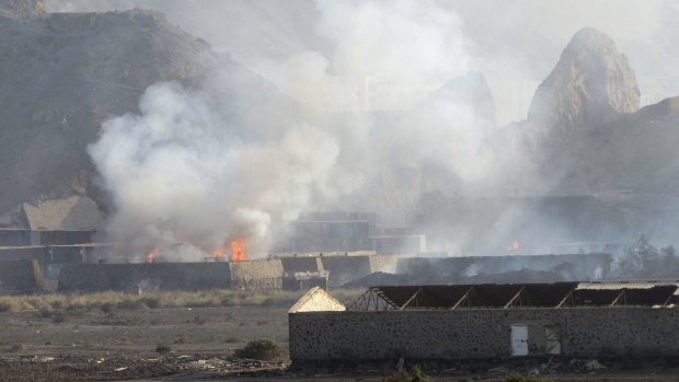Buildings at the Jabal al-Hadid military camp burn after air strikes in Aden, Yemen, on Saturday.