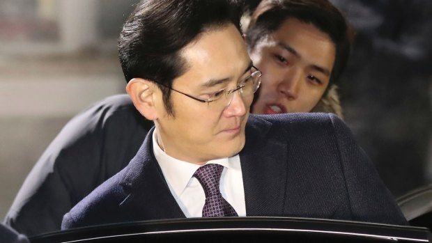 Lee Jae-yong, a vice-chairman of Samsung Electronics, gets into a car as he leaves after a Seoul court denied a request to arrest him.