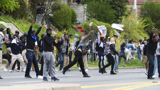 Demonstrators throw rocks to the police, after the funeral of Freddie Gray at New Shiloh Baptist Church in Baltimore. 