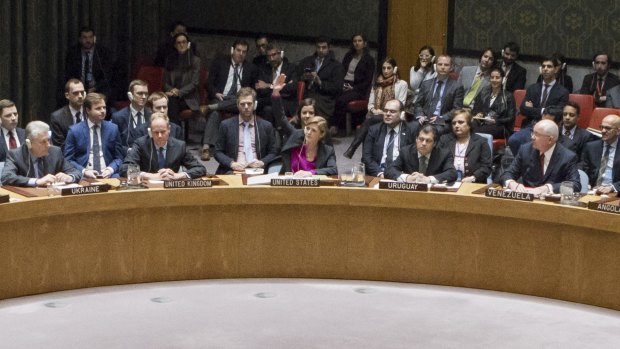US ambassador to the UN Samantha Power, centre, raises her hand to abstain during the UN Security Council vote on 23 December.