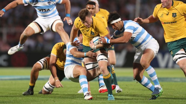 Bursting through: Jack Dempsey is tackled on the way to a 37-20 Wallabies win.