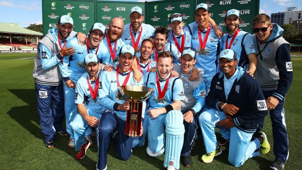 Champions: The Blues players enjoy victory in the domestic one-day cup at North Sydney Oval.