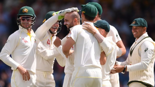 Bragging rights: Nathan Lyon gets the kudos after dismissing Joe Root off his first delivery.