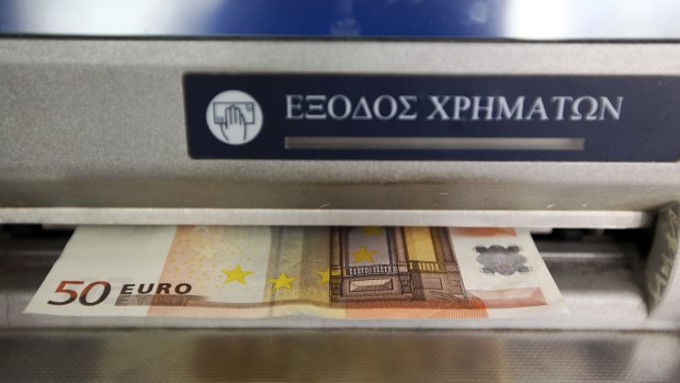 A €50 pops out of an Athenian ATM.