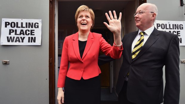 SNP Leader Nicola Sturgeon casts her vote in the Scottish Parliamentary election with her husband Peter Murrel, in Glasgow on Thursday.
