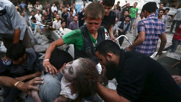 Men hold an injured girl rescued from a site hit by what activists said was heavy shelling by regime forces in the Douma district of Damascus.
 