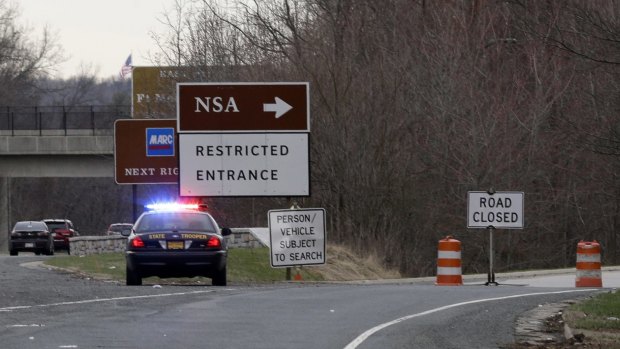 A Maryland State Police car sits at a blocked southbound entrance on the Baltimore-Washington Parkway that accesses the National Security Agency, after two people tried to ram the gates.