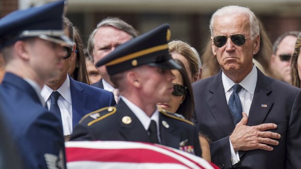 Vice President Joseph Biden places his hand on his heart as the casket of his son, former Delaware Attorney General Beau Biden, is carried into the church before a funeral mass at St. Anthony of Padua Church in Wilmington, Delaware.