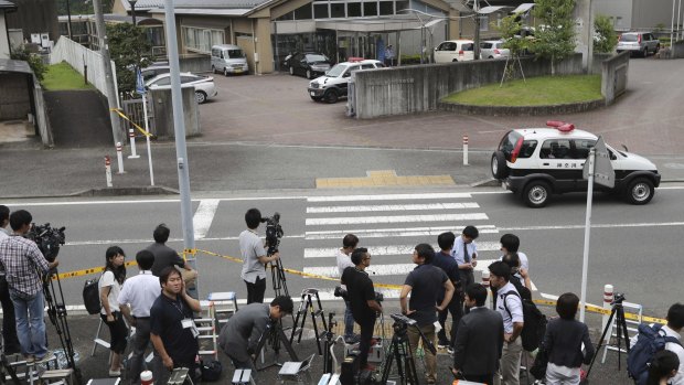 Journalists gather in front of Tsukui Yamayuri-en, a facility for the handicapped where a number of people were killed and dozens injured.
