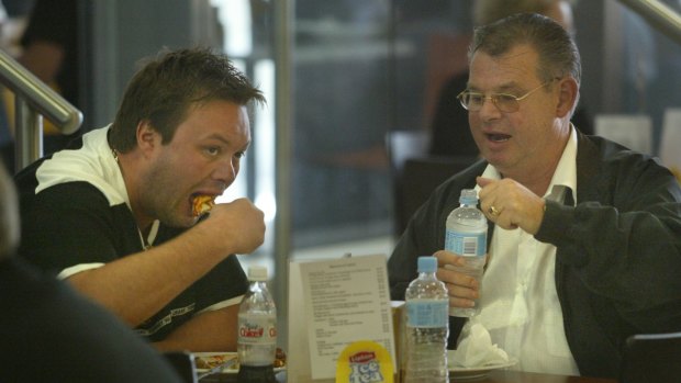 George and Carl Williams enjoy a meal near court in 2004.