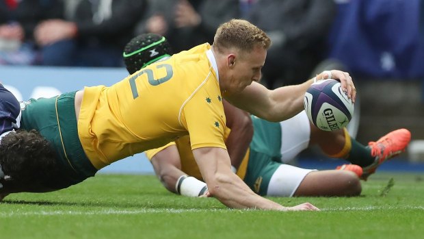 Reece Hodge scores Australia's first try against Scotland.
