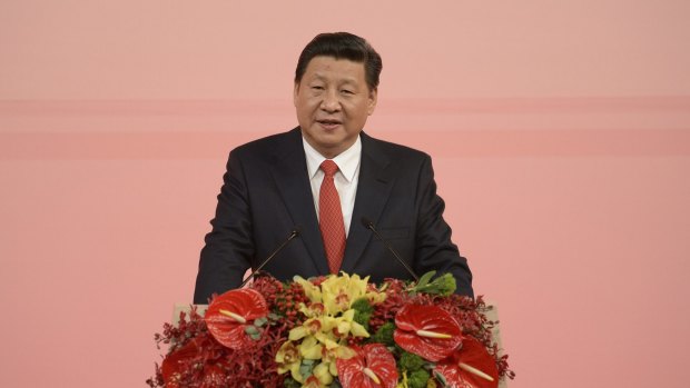 Shielded from protesters: Chinese President Xi Jinping gives a speech during his visit to Macau.