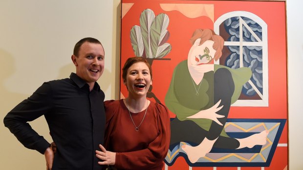 Mitch Cairns, the winner of the Archibald Prize, with his winning painting and its subject, his artist partner Agatha Gothe-Snape.
