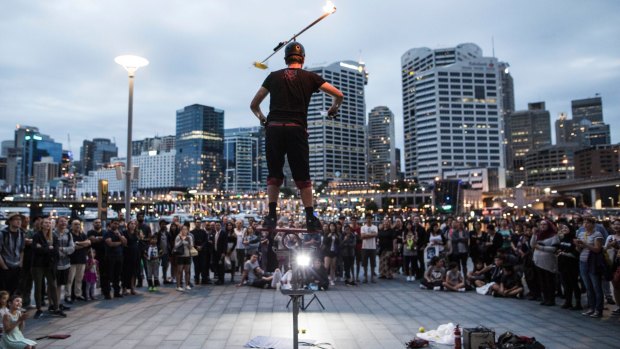 Daniel Nimmo performs his circus stunt show in front of a crowd in Darling Harbour.